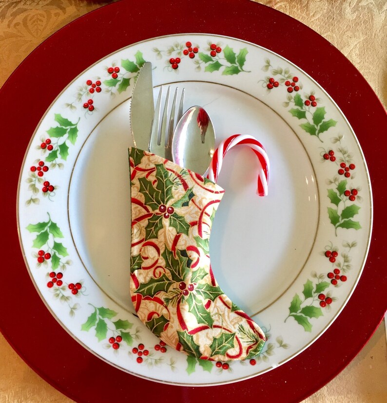Christmas Sock Silverware Holder in a Holly Print with a Red Ribbon on Cream background image 3