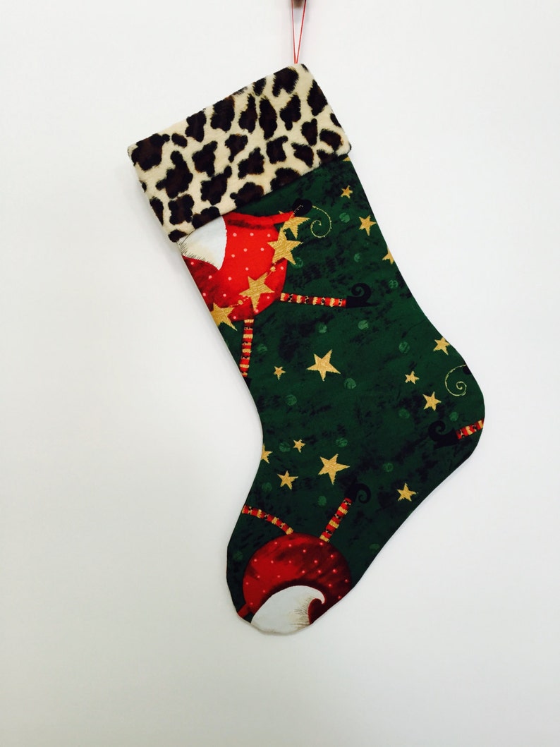 Whimsical Santa wearing Faux fur hats on Green Background with Faux Cheetah fur Cuff