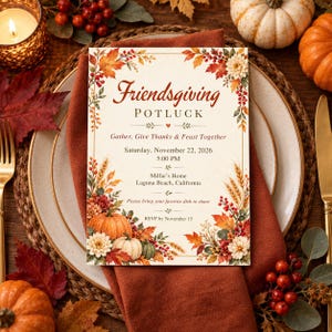 May include: A cream-colored Friendsgiving potluck invitation card featuring a decorative border of autumn leaves, wheat stalks, red berries, and pumpkins. The text reads Friendsgiving POTLUCK, Gather, Give Thanks & Feast Together, Saturday, November 22, 2026, 5:00 PM, Millie's Home, Laguna Beach, California, Please bring your favorite dish to share, and RSVP by November 15.
