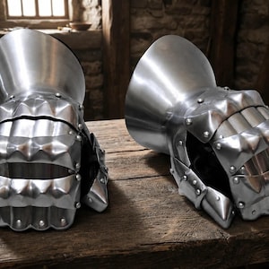 May include: A pair of polished steel gauntlets featuring articulated finger plates, a flared cuff, and visible rivets. The metal armour pieces are constructed with multiple overlapping segments designed to protect the hand and wrist area.