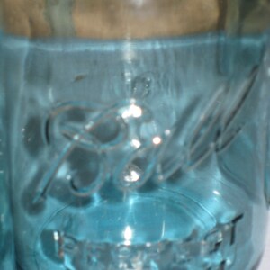 May include: A blue glass jar with the text "Ball" and "Perfect Mason" printed on the side.