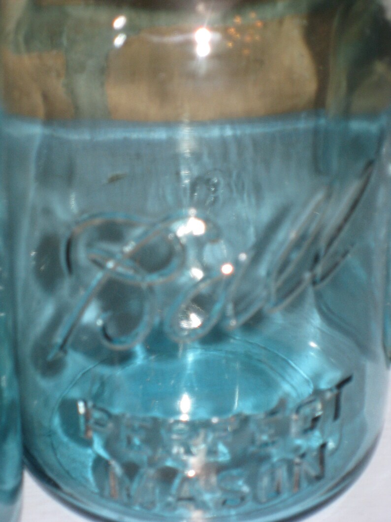 May include: A blue glass jar with the text "Ball" and "Perfect Mason" printed on the side.