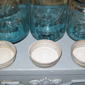 May include: Three blue glass jars with white lids. The jars are labeled "Ball Perfect Mason".