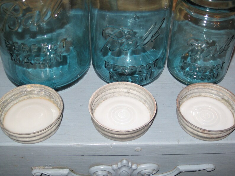May include: Three blue glass jars with white lids. The jars are labeled "Ball Perfect Mason".
