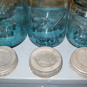 May include: Three blue glass jars with white lids. The jars are labeled "Ball Perfect Mason".