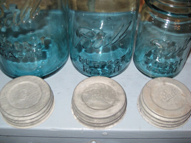 May include: Three blue glass jars with white lids. The jars are labeled "Ball Perfect Mason".
