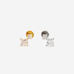 May include: Two pairs of earrings featuring a square-shaped clear stone. The earrings are available in gold and silver.