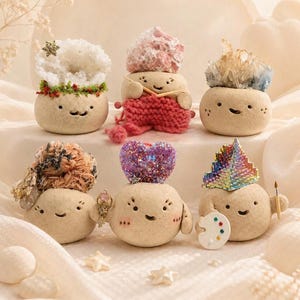 May include: A collection of whimsical, smiling stone figures, each adorned with unique decorative elements. One figure has a snowflake, another knits, and others feature crystals, a heart, and a painter's palette.