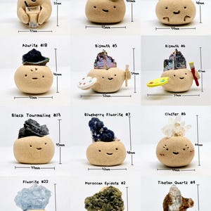May include: A collection of whimsical ceramic figures, each topped with a different gemstone. The figures have smiling faces and are labeled with the gemstone type and a number. Measurements are in millimeters.