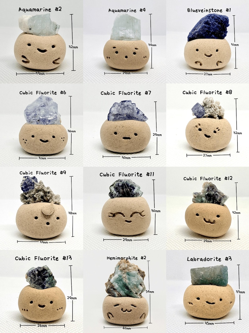 May include: A collection of small, tan ceramic pots, each with a unique gemstone on top. The gemstones vary in color, including blue, green, and purple. Each pot has a smiling face design and is labeled with a gemstone type and number.