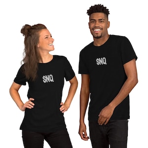 May include: Two people wearing black t-shirts with the text "SNQ" in white on the front.