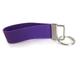 May include: Purple elastic key chain with a silver metal key ring.