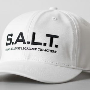 May include: A white baseball cap with the letters "S.A.L.T." printed in black on the front. Below the letters is the text "STAND AGAINST LEGALIZED TREACHERY". The cap has a curved brim and a button on top.
