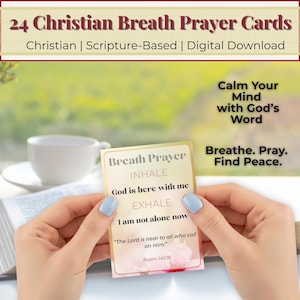May include: A person holding a Christian Breath Prayer card with the text "INHALE God is here with me EXHALE I am not alone now". The card is part of a set of 24 cards and includes the text "Calm Your Mind with God's Word" and "Breathe. Pray. Find Peace."