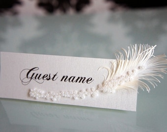 Ivory wedding place cards with feather & pearls