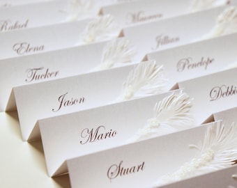 White Wedding place cards with pearls and feather decor | Luxury wedding table seating cards