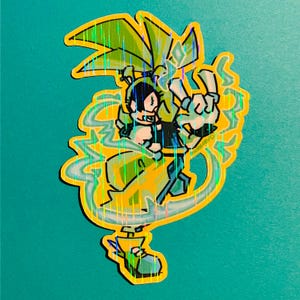 May include: A holographic sticker featuring a cartoon character with green hair and a yellow outfit. The character is making a peace sign with one hand and surrounded by yellow and blue energy effects. The sticker has a yellow border.