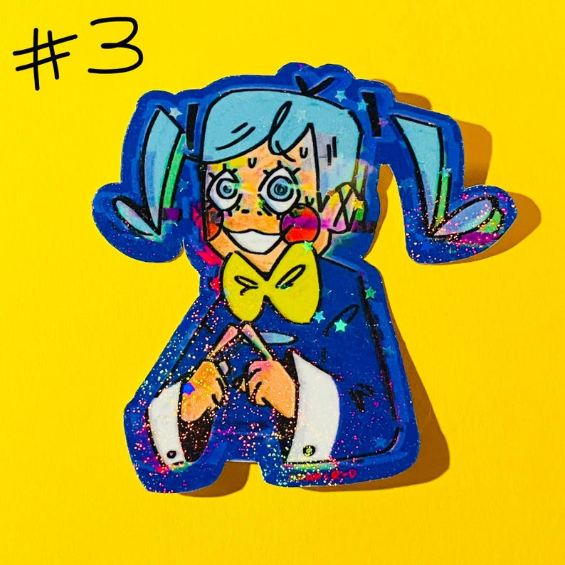 May include: A colorful sticker featuring a cartoon character with blue hair in pigtails, a yellow bow tie, and a blue suit. The sticker has a glittery finish and the number "#3" is in the top left corner. The background is yellow.