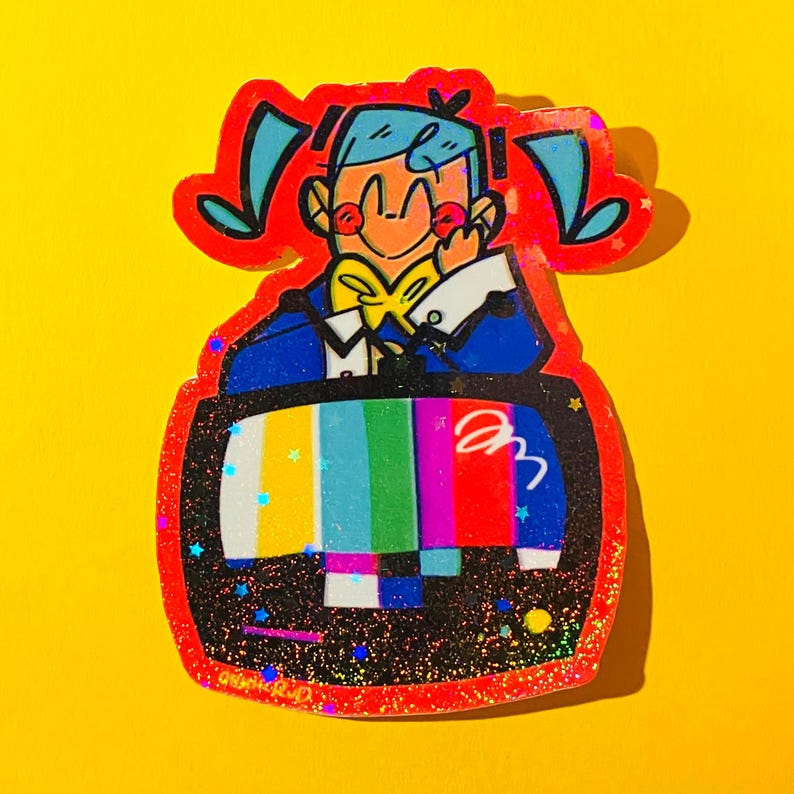 May include: A colorful sticker featuring a cartoon character with blue hair and a yellow bow tie, framed by a red outline. The character is inside a retro television with a rainbow test pattern. The background is yellow.