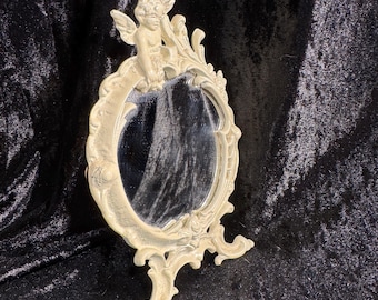 Espejo de tocador ornamentado con querubín. Hierro fundido antiguo/vintage.