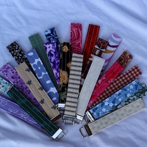Quilted hand made wristlet/ keychain holder, 23 different color variations . All include silver hardware.