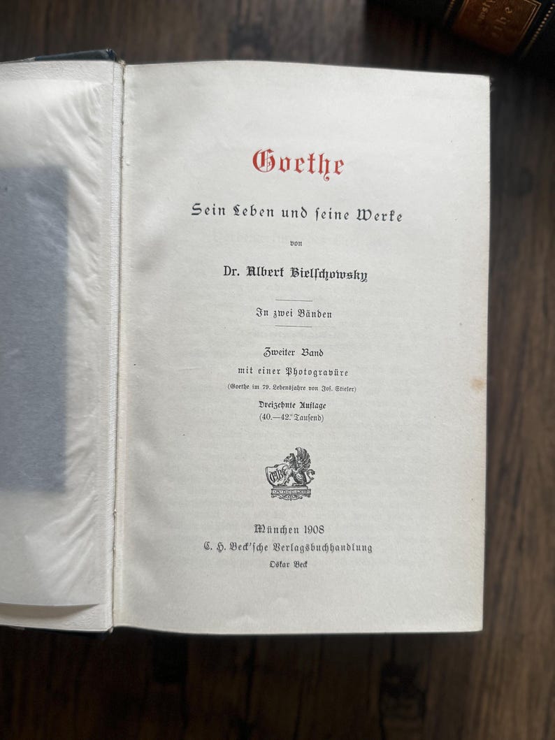 Puede incluir: P&aacute;gina de libro abierta con texto en alem&aacute;n. El t&iacute;tulo "Goethe" est&aacute; en escritura roja. El texto incluye "Sein Leben und seine Werke" y "Dr. Albert Bielschowsky". El libro es de 1908, publicado por C.H. Beck'sche Verlagsbuchhandlung.