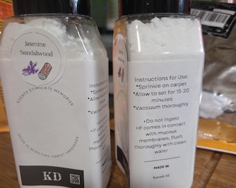 May include: Two clear plastic bottles filled with white powder, labeled Jasmine Sandalwood odor eliminating carpet freshener. The labels feature instructions to sprinkle on carpet, allow to set for 15-20 minutes, and vacuum thoroughly, with a KD logo.