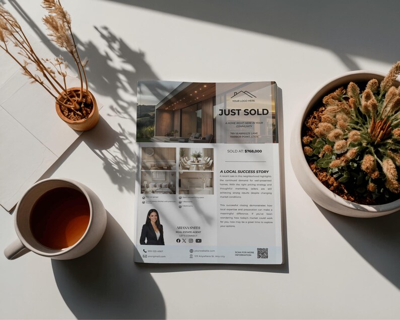 May include: A real estate flyer with the headline "JUST SOLD" and a photo of a modern home. The flyer includes photos of the home's interior, a real estate agent's photo, and contact information. A cup of coffee and a potted plant are also visible.