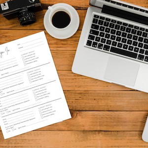 May include: A top-down view of a wooden desk with a laptop, a cup of coffee, a camera, a mouse, a pen, and a "Please Sign In" form. The form has fields for name, email, and checkboxes for current needs.