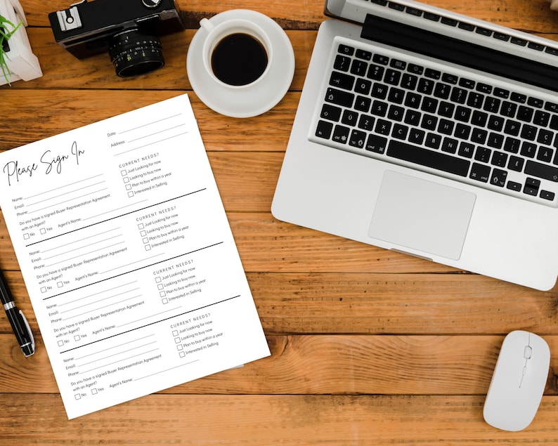 May include: A top-down view of a wooden desk with a laptop, a cup of coffee, a camera, a mouse, a pen, and a "Please Sign In" form. The form has fields for name, email, and checkboxes for current needs.