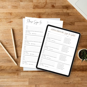 May include: An open house sign-in sheet on a tablet and a paper form, with the text "Please Sign In" and "Open House Sign In Sheet". Two pencils and a small potted plant are also on the wooden surface.