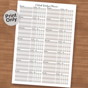 May include: A white 2-week workout planner with a light gray design. The planner includes sections for each day of the week, with space for time, reps, and sets. The words "2 Week Workout Planner" are at the top.
