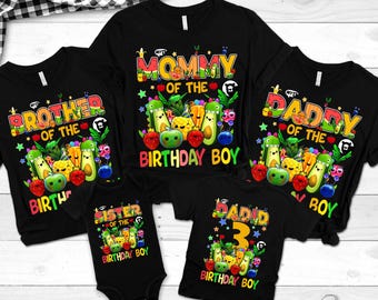 May include: Black t-shirts and a onesie with colorful birthday-themed graphics. The shirts read "Mommy", "Daddy", "Brother", and "Sister" with fruit and vegetable illustrations. One shirt says "David 3 Birthday Boy".