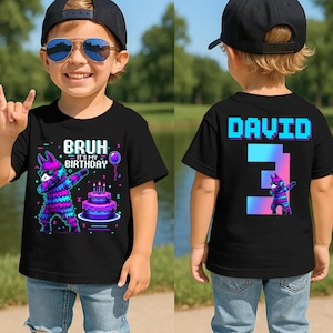 May include: Black t-shirt with a colorful graphic of a piñata dabbing, a birthday cake, and the text "BRUH - IT'S MY BIRTHDAY." The back of the shirt has the name "DAVID" and the number "3" in a pixelated font, with a matching piñata.