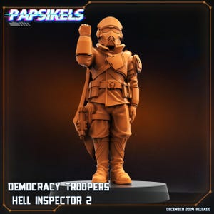 May include: A 3D printed miniature figure of a soldier wearing a helmet and a brown uniform. The figure is holding a weapon in its right hand and has a skull symbol on its belt. The figure is standing on a black base. The text "DEMOCRACY TROOPERS HELL INSPECTOR 2" is printed below the figure.
