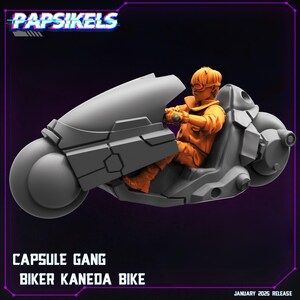 May include: A grey and black futuristic motorcycle with a single rider. The rider is wearing an orange jumpsuit and a helmet. The motorcycle has a large, round front wheel and a smaller rear wheel. The text "CAPSULE GANG BIKER KANEDA BIKE" is printed below the motorcycle.