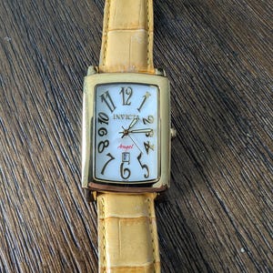 Women&#39;s Invicta Angel gold tone watch mother of pearl dial