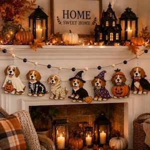 May include: A Halloween-themed garland featuring seven beagle puppies in various costumes, including a ghost, skeleton, mummy, witch, wizard, pumpkin, and vampire, strung on a twine cord with black and white wooden beads for seasonal decor.