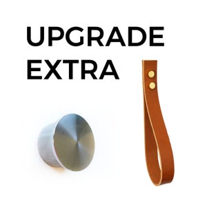 May include: Upgrade Extra text with a silver knob and a brown leather strap with two gold metal rivets.