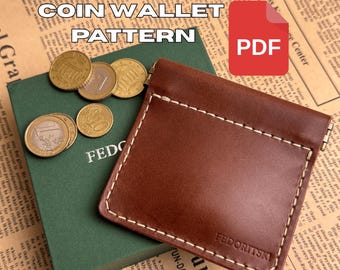 May include: A brown leather coin wallet with white stitching, next to a green book and several coins. The text "COIN WALLET PATTERN" is displayed above the wallet. A red PDF icon is in the upper right corner.