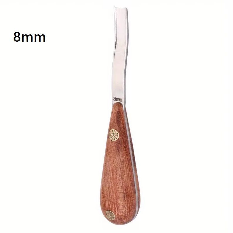 May include: A wood carving tool with an 8mm blade. The tool features a curved, stainless steel blade and a teardrop-shaped wooden handle. The handle is a rich brown color and is adorned with two decorative brass accents.