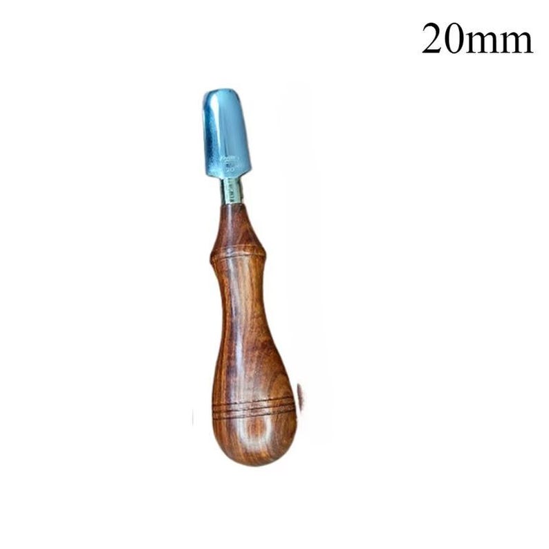 May include: A wood-handled tool with a silver-colored blade. The handle is a dark brown color with a curved shape and two horizontal grooves. The blade is 20mm in length.