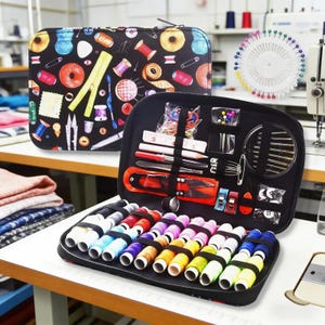 May include: A black sewing kit with a colorful pattern of sewing notions, open to reveal spools of thread, needles, scissors, and other tools. A pinwheel and a closed sewing kit are also visible.