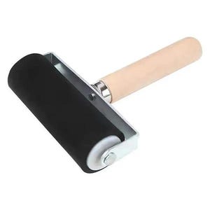 May include: A brayer tool featuring a cylindrical black rubber roller attached to a silver metal frame. The handle is made of smooth, light-colored wood and is connected to the metal frame by a silver-toned metal ferrule at the base.