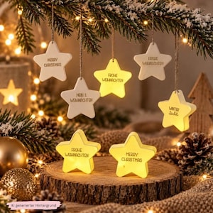 May include: A collection of star-shaped ornaments and light-up figures. Some stars hang from branches with text reading Merry Christmas, Frohe Weihnachten, Mein 1. Weihnachten, and Winter Licht. Two illuminated stars sit on a wooden base.
