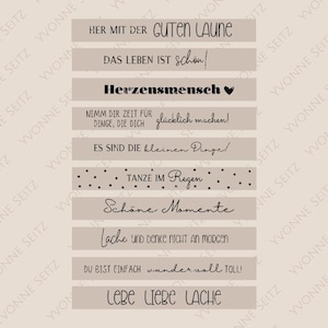May include: Beige background with nine black text banners. The banners feature motivational quotes in German. The quotes include "Her mit der guten Laune", "Das Leben ist schön!" and "Tanzen im Regen".