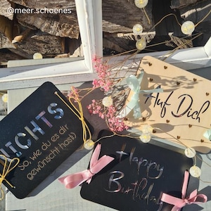 May include: Three black wooden signs with white lettering. The first sign says "NICHTS So, wie du es dir gew&uuml;nscht hast". The second sign says "Happy Birthday". The third sign says "Auf Dich?"