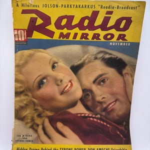 May include: Vintage "Radio Mirror" magazine cover featuring a couple. The cover is yellow and blue with the title "Radio Mirror" in large red letters. The cover also includes the text "November" and the names "Sonja Henie" and "Tysone Power".