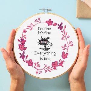 May include: Embroidered hoop art with a black cat and pink flowers. The text reads "I'm fine, It's fine, Everything is fine."
