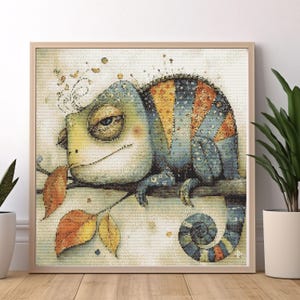 May include: A framed illustration of a cartoon chameleon on a branch. The chameleon is depicted with a blue, yellow, and orange patterned body and a curled tail. The artwork features autumn leaves and a neutral background.